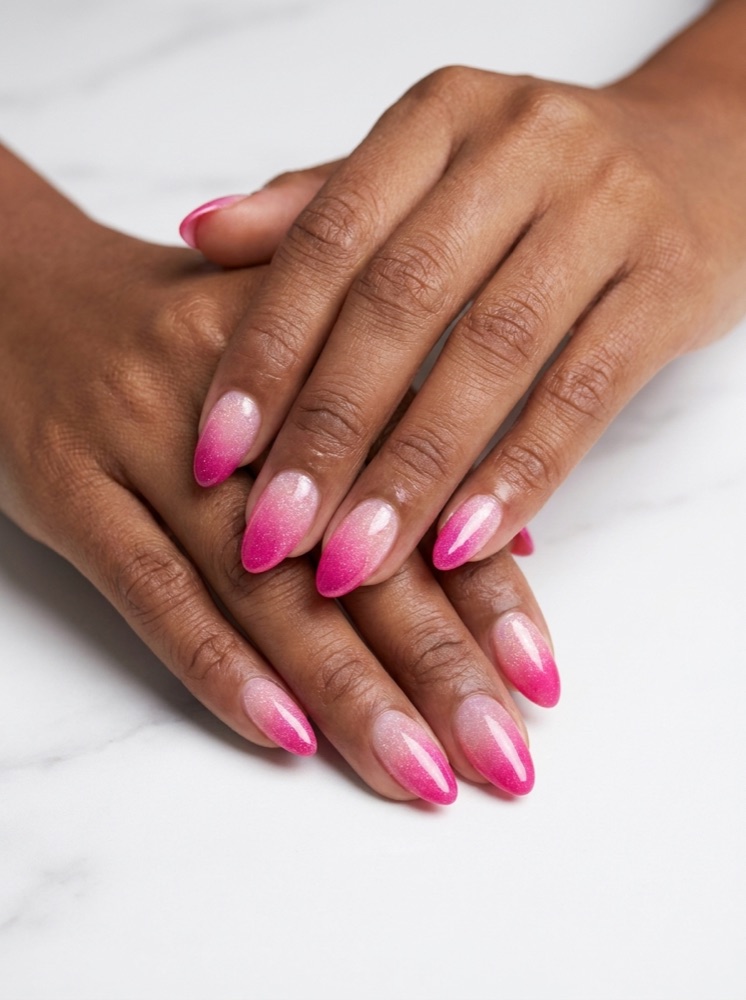 Almond nails with shimmery ombré fading from pearl to vivid pink